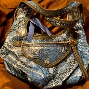 Navy blue purse with a lot of pockets.